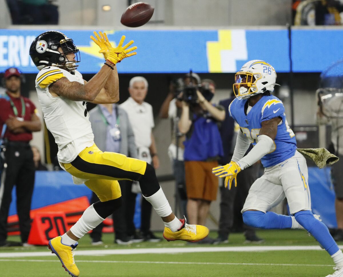 Pittsburgh Steelers wide receiver Chase Claypool hauls in a long pass over Chargers cornerback Asante Samuel Jr.