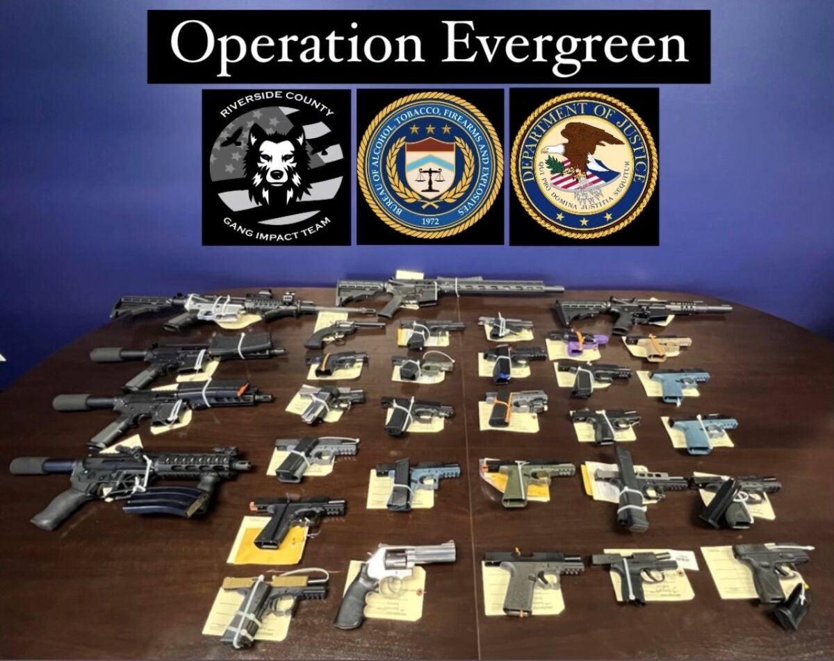 Several pistols, rifles and other guns on a table under the name "Operation Evergreen"