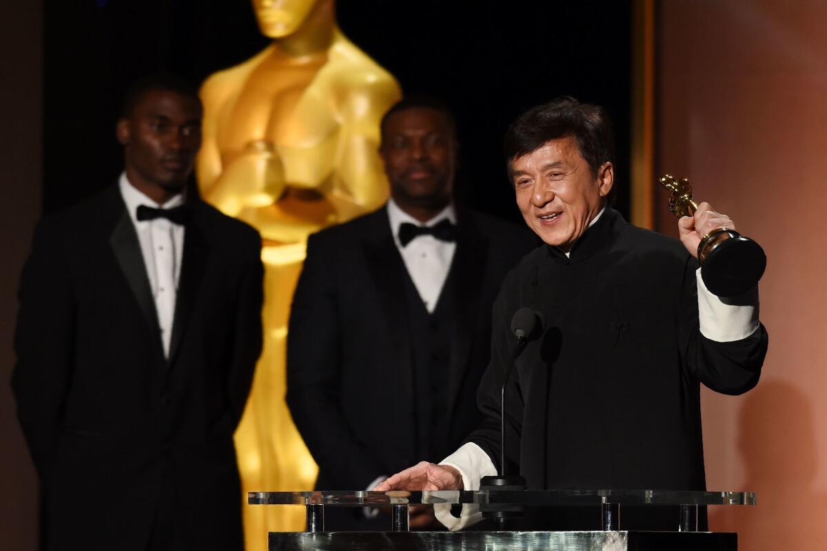 Actor Jackie Chan accepts his Oscar during the Governors Awards.