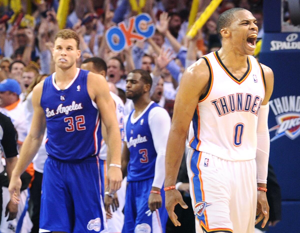 Oklahoma City's Russell Westbrook celebrates in front of Clippers Blake Griffin and Chris Paul late in Game 5 of the NBA Western Conference playoffs on May 13.