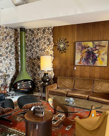 Midcentury Modern furniture including a metal fireplace in a living room vignette at Sunbeam Vintage.