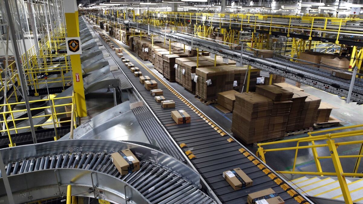 Packages ride on a conveyor system at an Amazon fulfillment center in Baltimore.