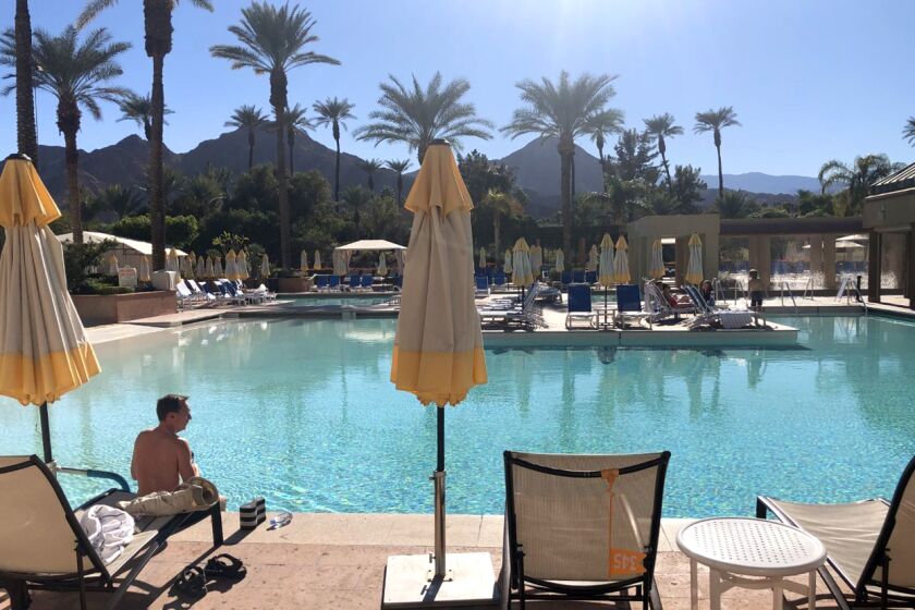 A guest has most of the pool area to himself at the Renaissance Esmeralda Resort in Indian Wells, which was about 20% occupied on Friday as state authorities worked out details on tighter pandemic restrictions.