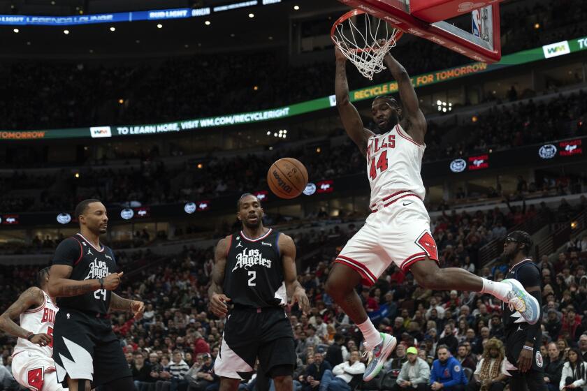 Chicago Bulls forward Patrick Williams dunks the ball during the first half of an NBA basketball game against the Los Angeles Clippers Tuesday, Jan. 31, 2023, in Chicago. (AP Photo/Erin Hooley)