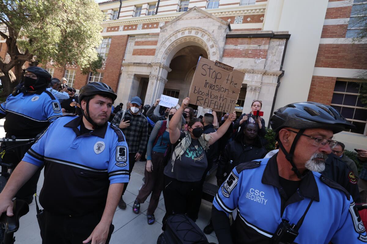 Demonstrators and security personnel at UCLA on Monday.