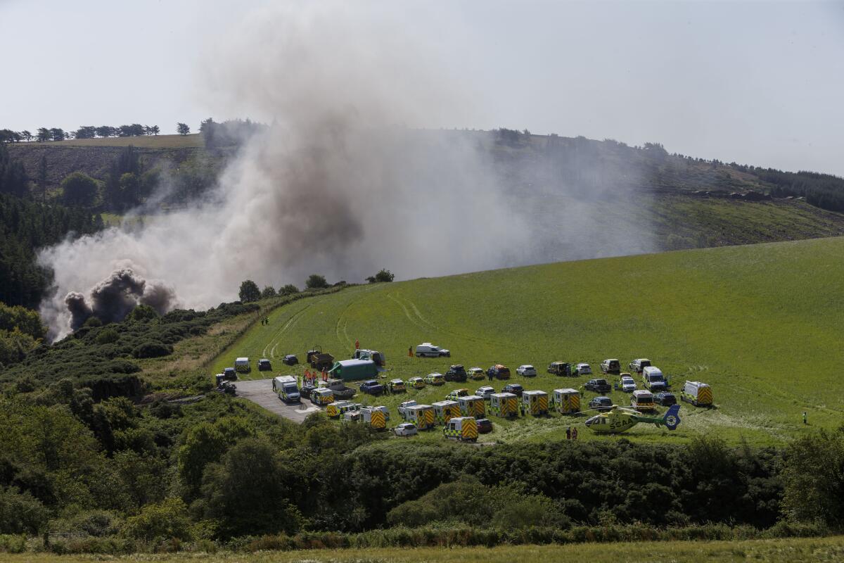 Emergency workers respond to the scene of a derailed train in Scotland.