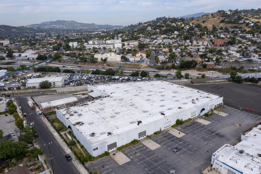 Lincoln Heights, California - April 26: Drone image of a warehouse at 141 West Avenue 34 where a developer wants to build a five-story apartment complex Tuesday, April 26, 2022 in Lincoln Heights, California. Residents who live near the site protested the plan, saying the site was full of toxic waste and that they'd be exposed. (Brian van der Brug / Los Angeles Times)