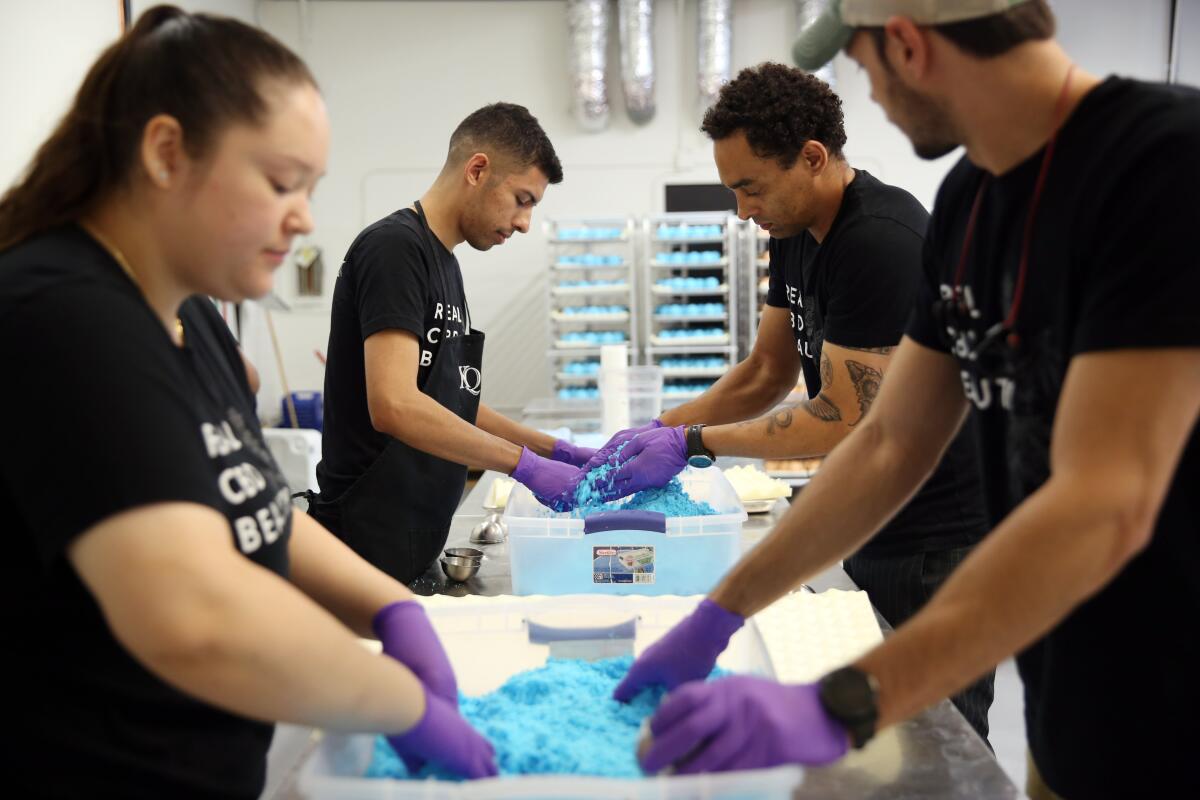 Kush workers (left to right) Irma Morales, Christian Salto, Christopher Lee and Blake Owens at the Anaheim offices.