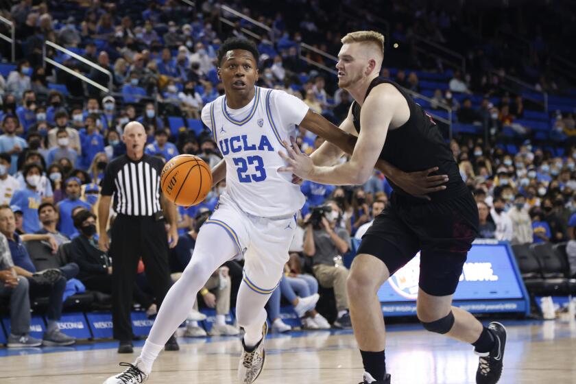 UCLA guard Peyton Watson (23) drives against Chico State forward Dylan Belquist (24) in the second half of an NCAA college basketball exhibition game Thursday, Nov. 4, 2021, in Los Angeles. (AP Photo/Ringo H.W. Chiu)