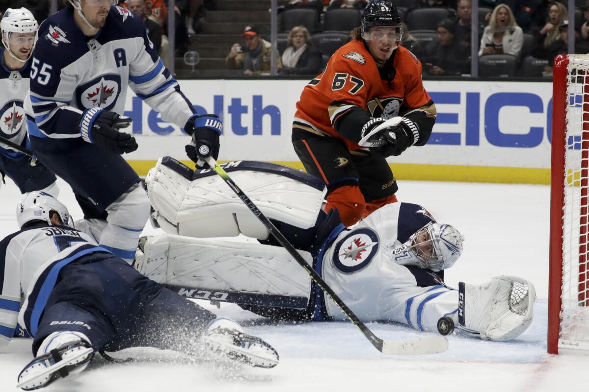 Jets goalie Connor Hellebuyck stops a Ducks shot Friday. He made 24 saves for his second shutout this season.