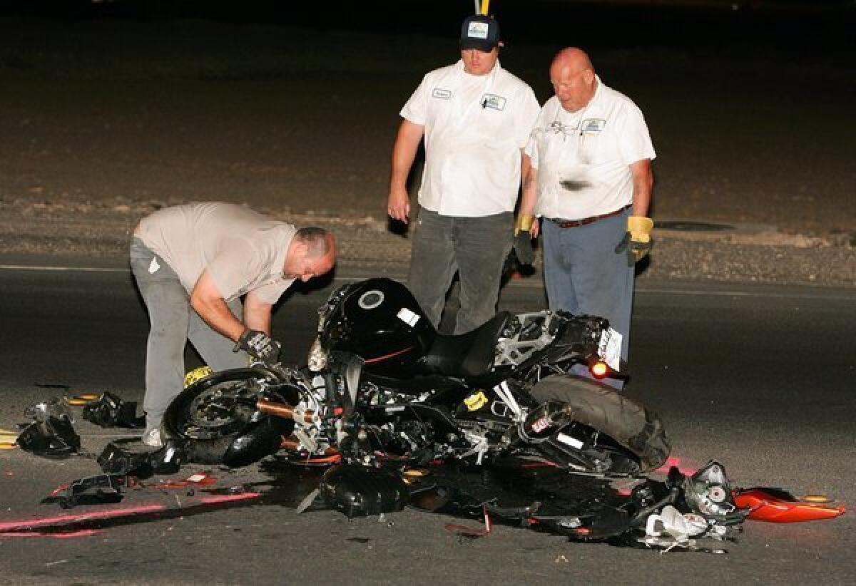 Officials inspect the scene of a fatal motorcycle crash in Las Vegas. According to a new study, motorcycle fatalities in the U.S. rose 9% last year.
