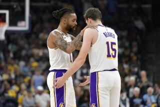 Los Angeles Lakers guards D'Angelo Russell (1) and Austin Reaves (15) talk during Game 1 of a first-round NBA basketball playoff series against the Memphis Grizzlies, Sunday, April 16, 2023, in Memphis, Tenn. (AP Photo/Brandon Dill)