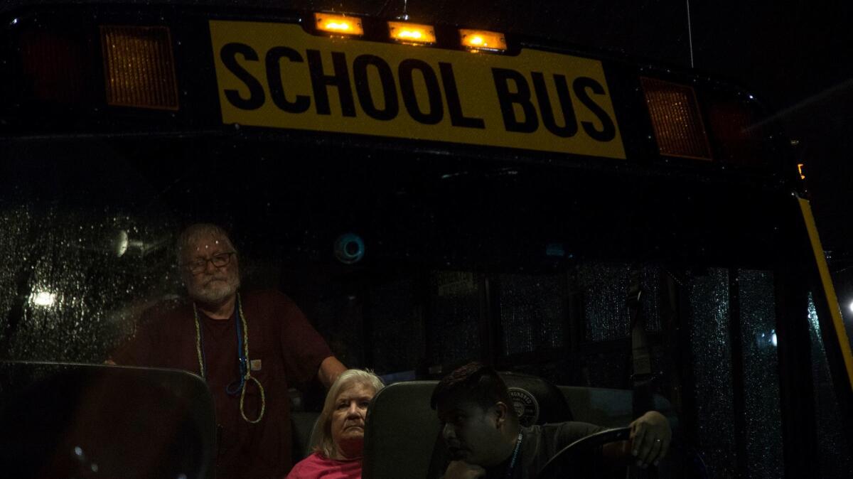 Tropical Storm Harvey evacuees arrive by bus to a shelter at B.F. Terry High School in Rosenberg, Texas, on Aug. 28, 2017.