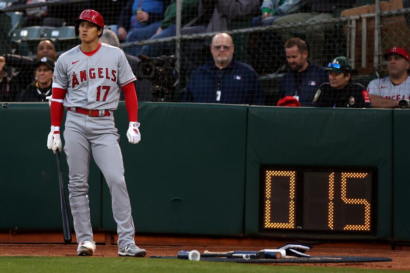 OAKLAND, CALIFORNIA - MARCH 30: Shohei Ohtani #17 of the Los Angeles Angels stands by the new pitch clock.