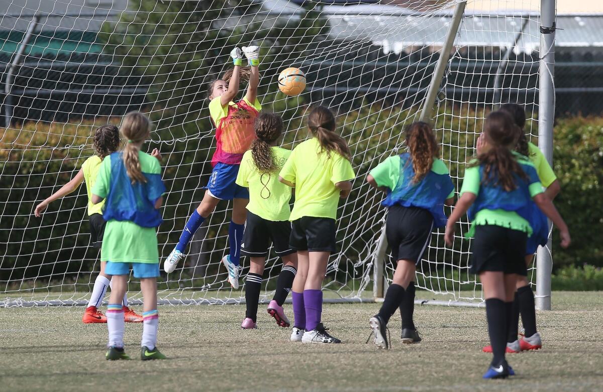 Newport Coast Elementary goalkeeper Willow Boyd makes a save against Pegasus in a girls’ fifth- and sixth-grade Silver Division pool-play match at the Daily Pilot Cup on Friday at Jack R. Hammett Sports Complex in Costa Mesa.