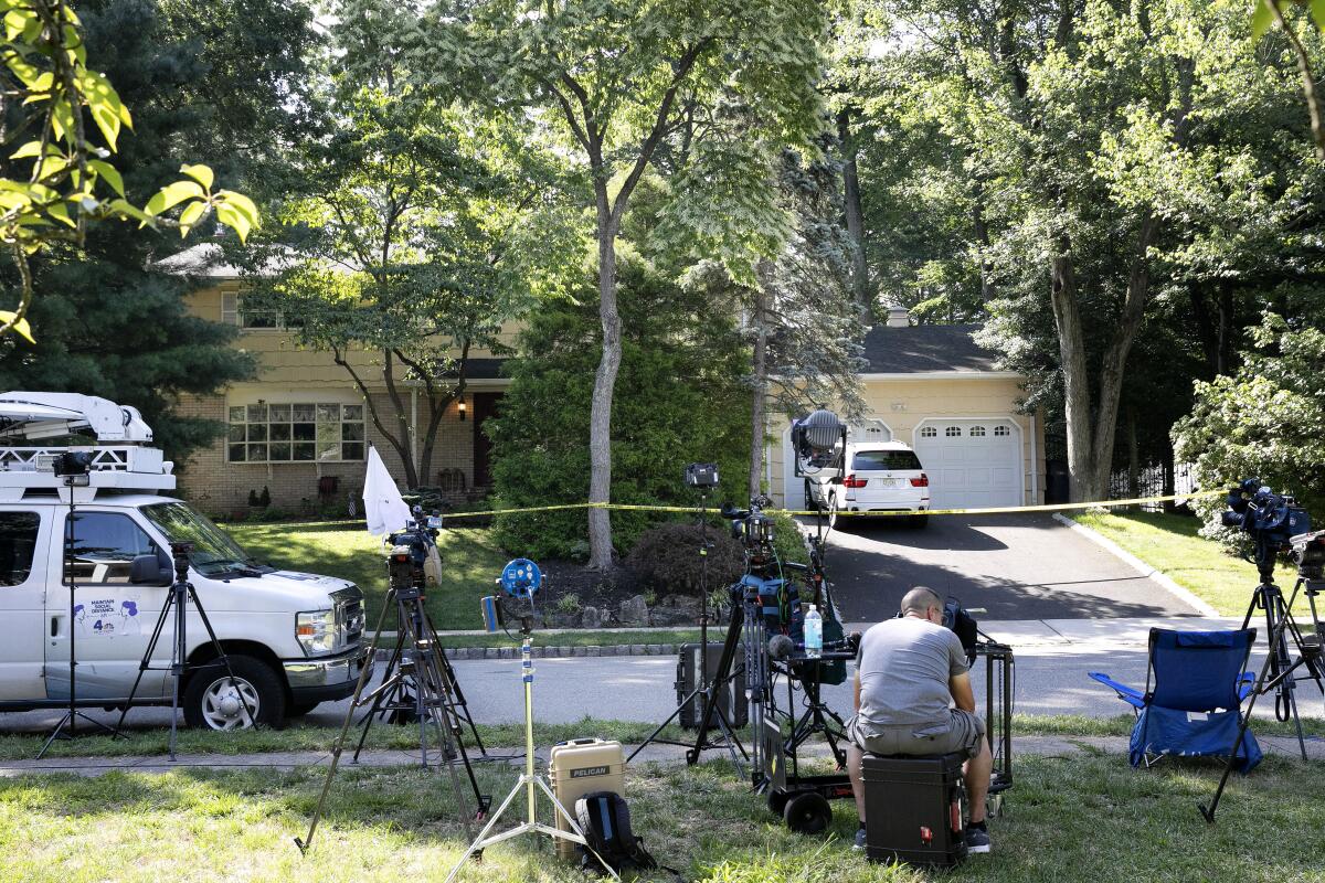 Members of the news media outside the home of U.S. District Judge Esther Salas.