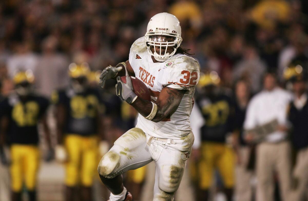 Texas running back Cedric Benson runs to daylight against Michigan in the 91st Rose Bowl game on Jan. 1, 2005.