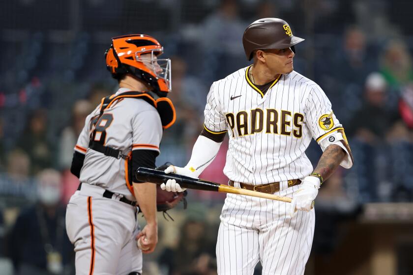 SAN DIEGO, CALIFORNIA - APRIL 30: Manny Machado #13 of the San Diego Padres looks on after striking out during the first inning of a game as Buster Posey #28 of the San Francisco Giants looks on at PETCO Park on April 30, 2021 in San Diego, California. (Photo by Sean M. Haffey/Getty Images)
