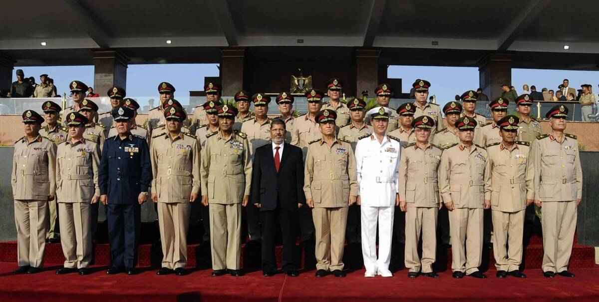 President Mohamed Morsi, center, with Egypt's ruling generals after his inaguration ceremony in Cairo.