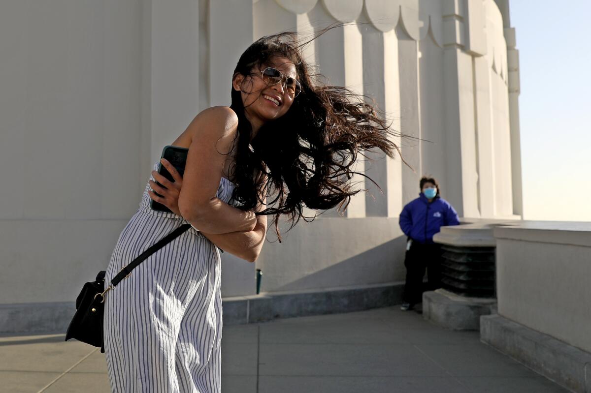 With hair blowing in the wind, Theresa Johnson of Lake Tahoe has her photo taken at Griffith Observatory.