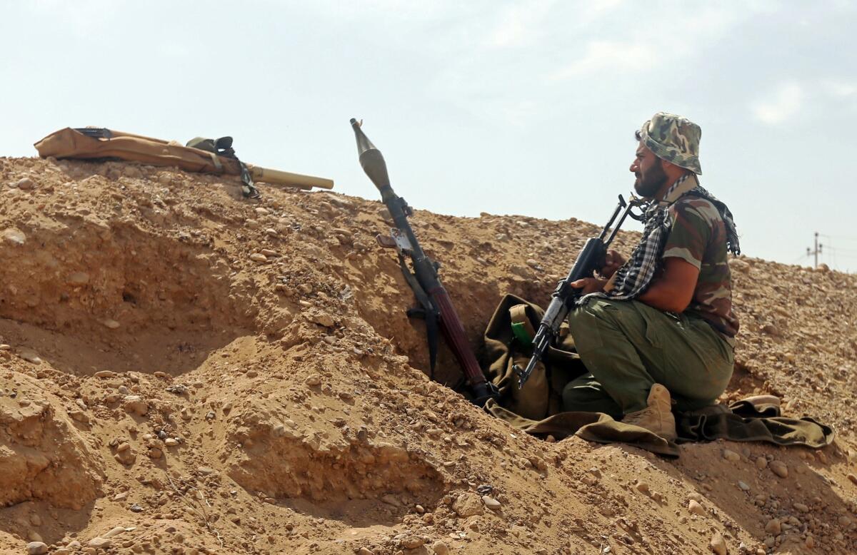 An Iraqi militiaman holds a position in the Nibaie area northwest of Baghdad on May 27 during an operation aimed at cutting off Islamic State fighters in Anbar province before a major offensive to retake the city of Ramadi.