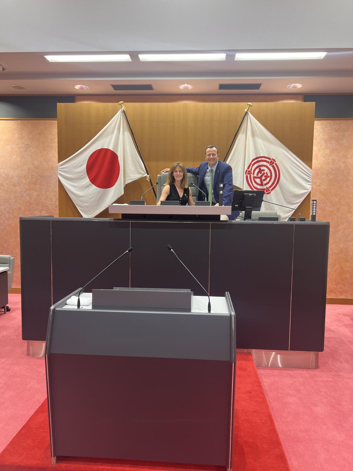 Newport Beach Councilwoman Robyn Grant and Councilman Erik Weigand pose for a photo in the Okazaki City Council chambers.