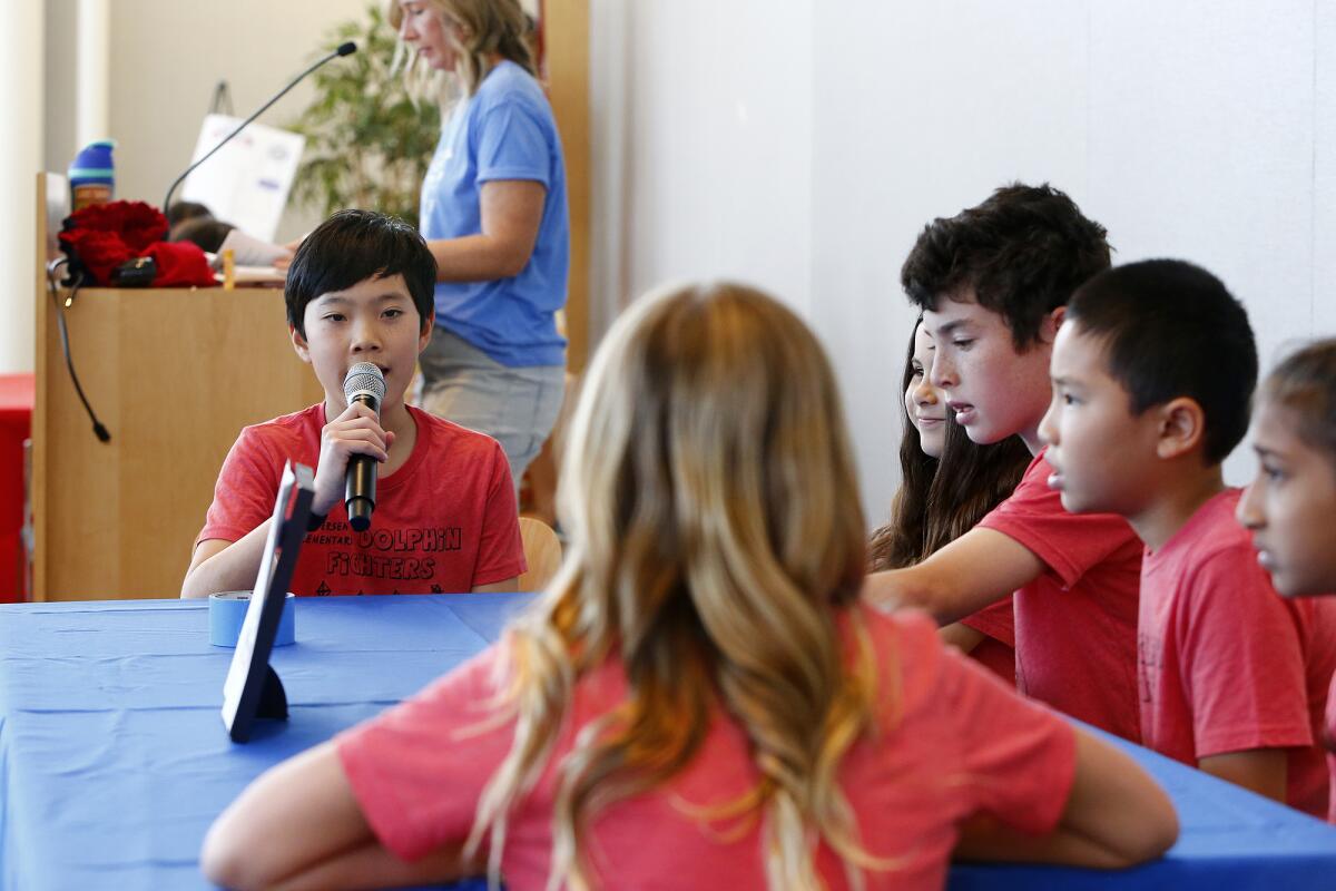 Andersen fifth-grader James Phan gives his team's answer.