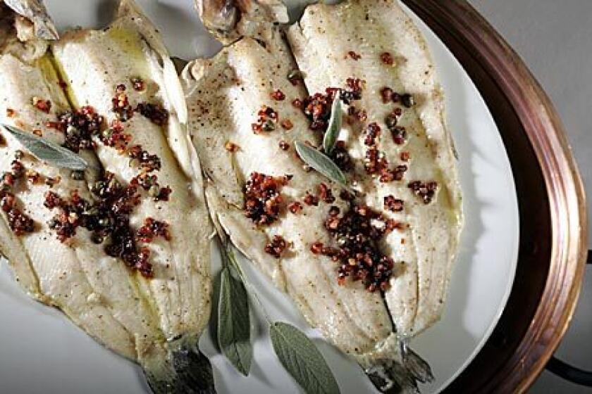 VIBRANT: A topping of pancetta, capers and sage is spooned over roasted trout fillets for a main course.