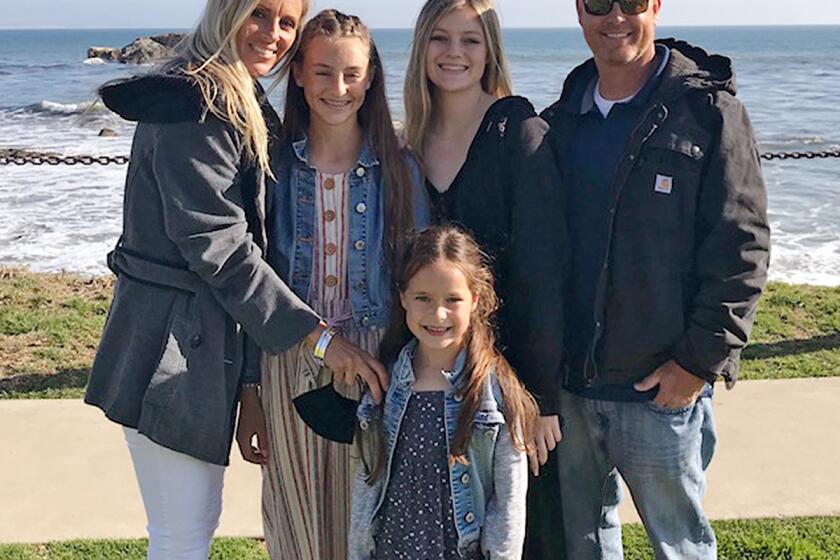 Undated handout photo of Tory Carlon, right, wis wife, Heidi, and their daughters.