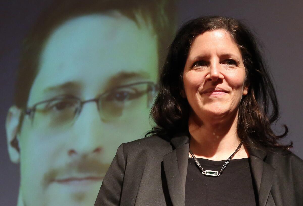 BERLIN, GERMANY - DECEMBER 14: Filmmaker Laura Poitras speaks as former National Security Agency (NSA) contractor turned whistleblower Edward Snowden is seen on a video conference screen during an award ceremony for the Carl von Ossietzky journalism prize on December 14, 2014 in Berlin, Germany.