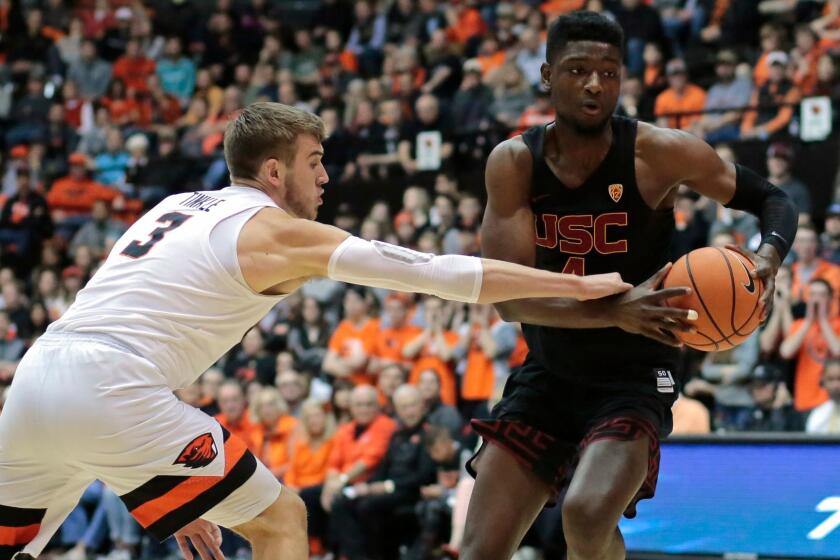 Southern California's Chimezie Metu (4) tries to get past Oregon State's Tres Tinkle (3) in the first half of an NCAA college basketball game in Corvallis, Ore., Saturday, Jan. 20, 2018. (AP Photo/Timothy J. Gonzalez)