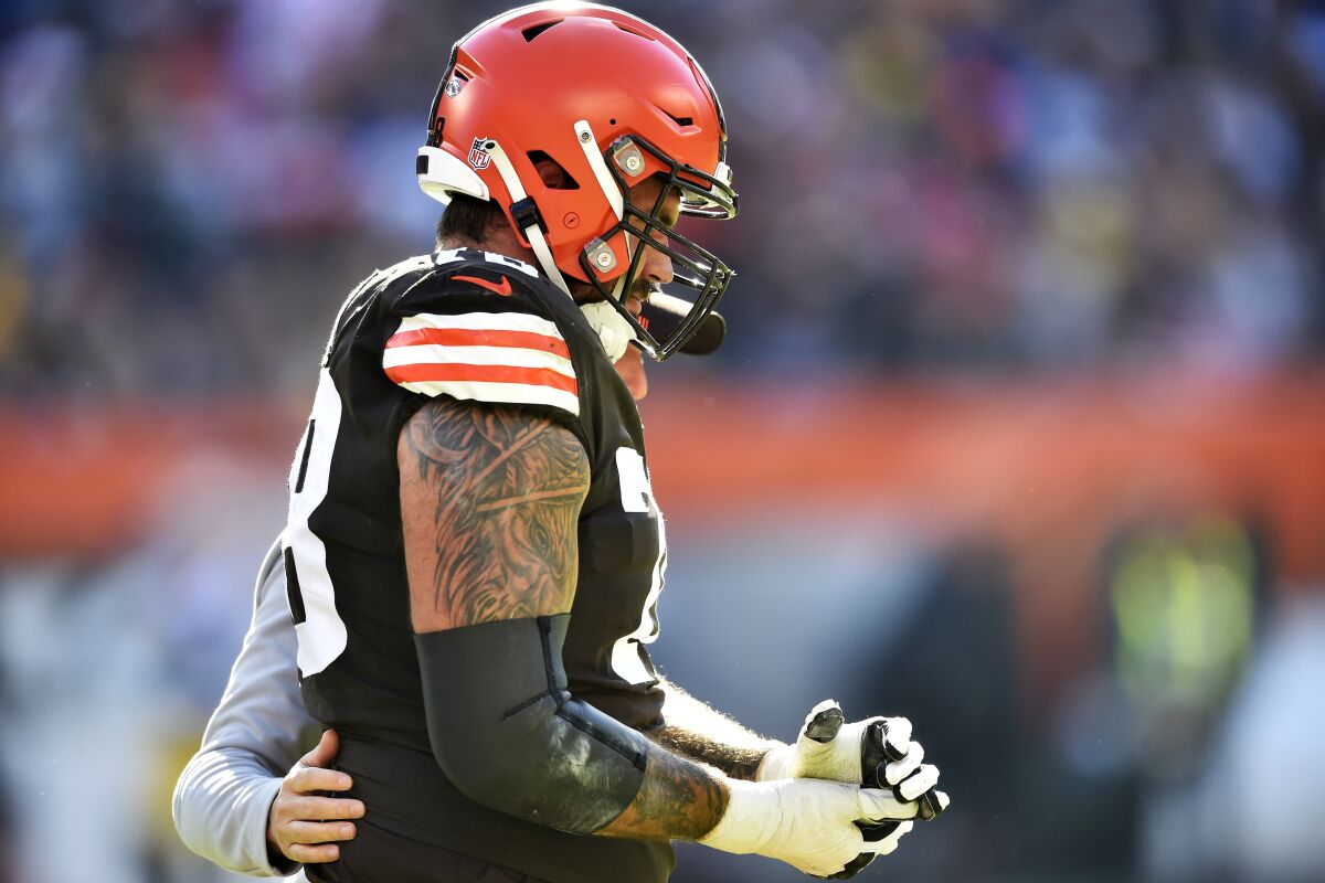 Cleveland Browns offensive tackle Jack Conklin walks off the field with an injury during the first half of an NFL football game against the Pittsburgh Steelers, Sunday, Oct. 31, 2021, in Cleveland. (AP Photo/David Richard)