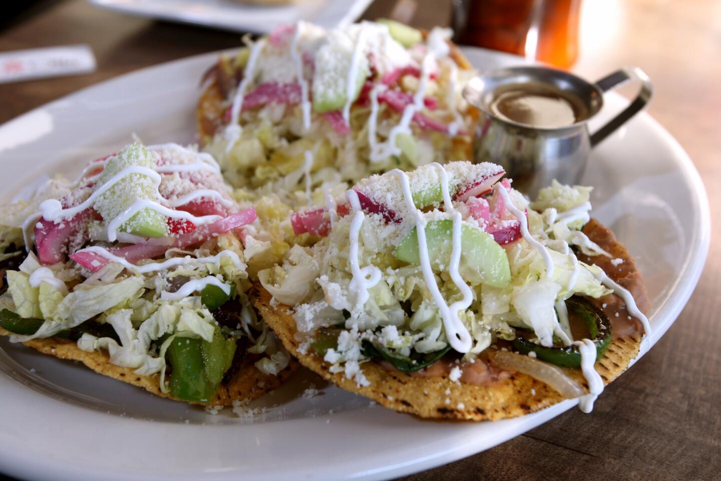 The Veggie tostadas come with tomato, bell pepper, red and white onions, cucumbers, Cotija cheese and Mexican sour cream, at Cafe de Olla restaurant, on the 2300 block of Victory Blvd. in Burbank on Tuesday, December 29, 2015. The Mexican and American traditional food restaurant opened in October 2015.