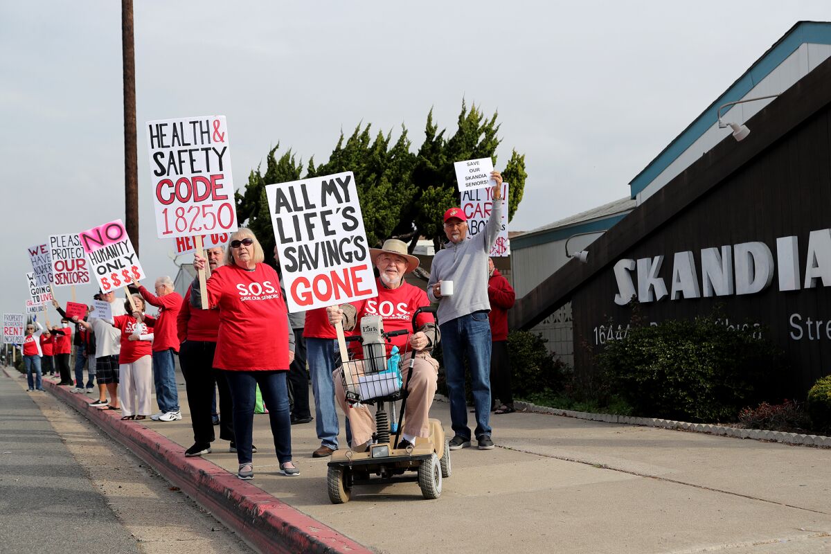 Bob Herold, 89, in his wheelchair, demonstrates against rent increases with fellow Skandia Mobile Home Park residents.