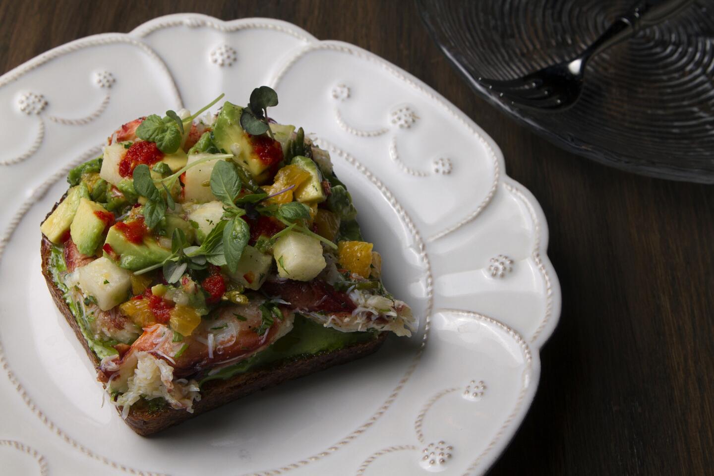 Dungeness crab toast is topped with jicama, avocado and a green goddess aioli. Some of the dishes at Faith & Flower are modern takes on cocktail snacks.