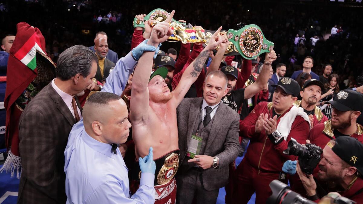 Canelo Alvarez celebrates after a WBA super middleweight championship boxing match against Rocky Fielding.