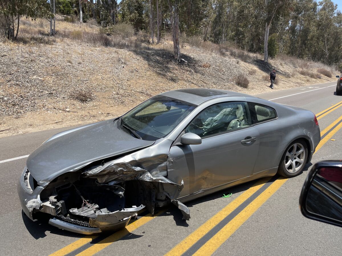 A vehicle that was in a head-on traffic collision sits on Pomerado Road in Scripps Ranch