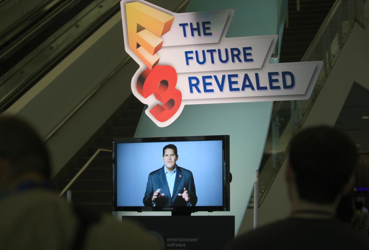 Members of the media listen to Reginald Fils-Aime, president and COO of Nintendo of North America, speak Tuesday during a news conference at E3, a trade show for computer and video games and related products at the Los Angeles Convention Center.