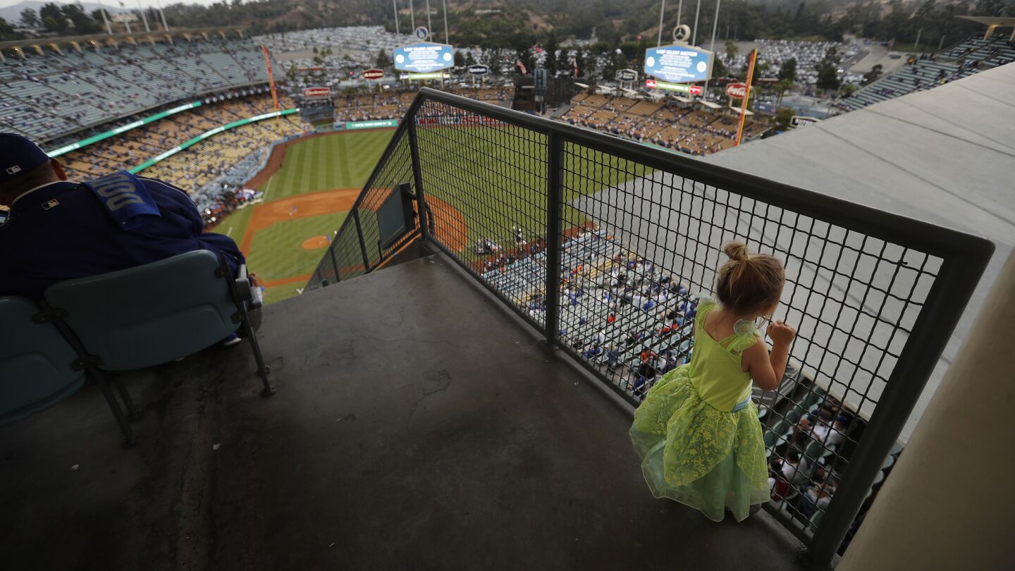 Madison Jack, 3, of Rancho Santa Margarita, wears her Tinker Bell costume while taking in the World Series scene before the Dodgers game.
