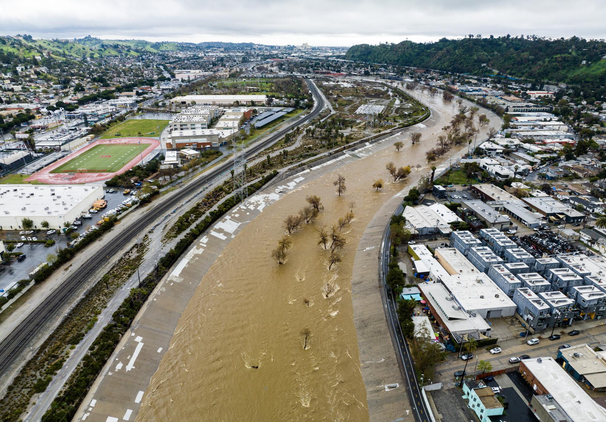 An aerial view of muddy water in the Los Angeles River.