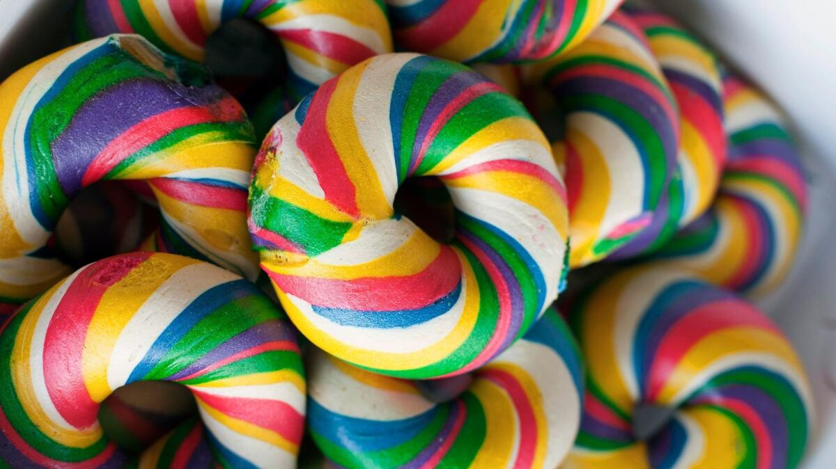 The brightly colored rainbow bagel is made daily by twirling together various dyed doughs at Bagels & Brew. (Photo by Meg Strouse) (Meg Strouse / Weekend)