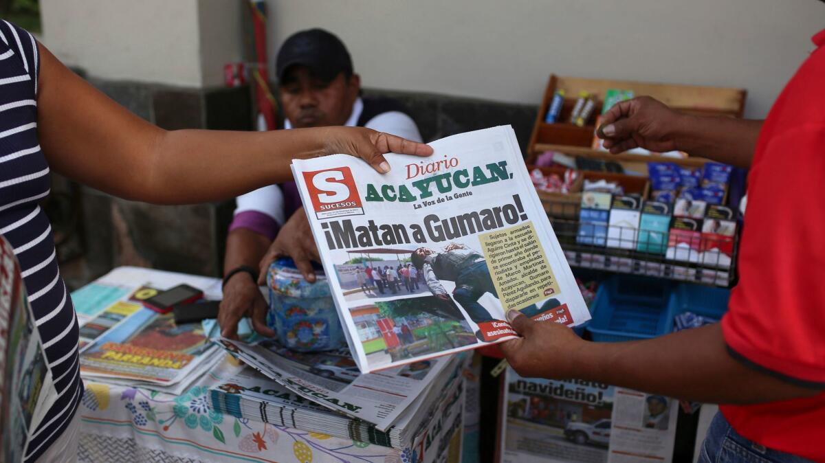 A newspaper reporting the death of journalist Gumaro Perez carries the headline "They killed Gumaro!" in Acayucan, Veracruz state, Mexico.