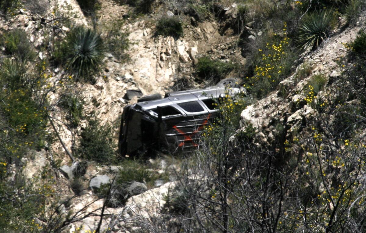 A vehicle rests on its side, found over the edge of the Angeles Crest Highway at mile marker 31.82 on Monday, April 8, 2013. No victims were found at the scene.