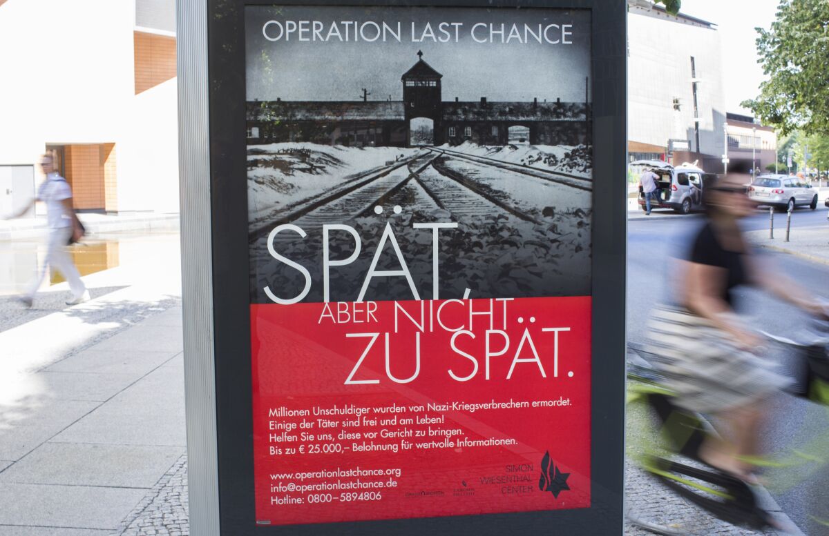 An Operation Last Chance placard reading "Late, but not too late" is displayed in Berlin on Tuesday.