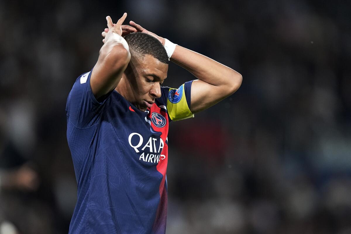 PSG's Kylian Mbappe reacts after missing a scoring chance during the French League One soccer match between Paris Saint Germain and Nice at Parc des Princes stadium in Paris, Friday, Sept. 15, 2023. (AP Photo/Michel Euler)