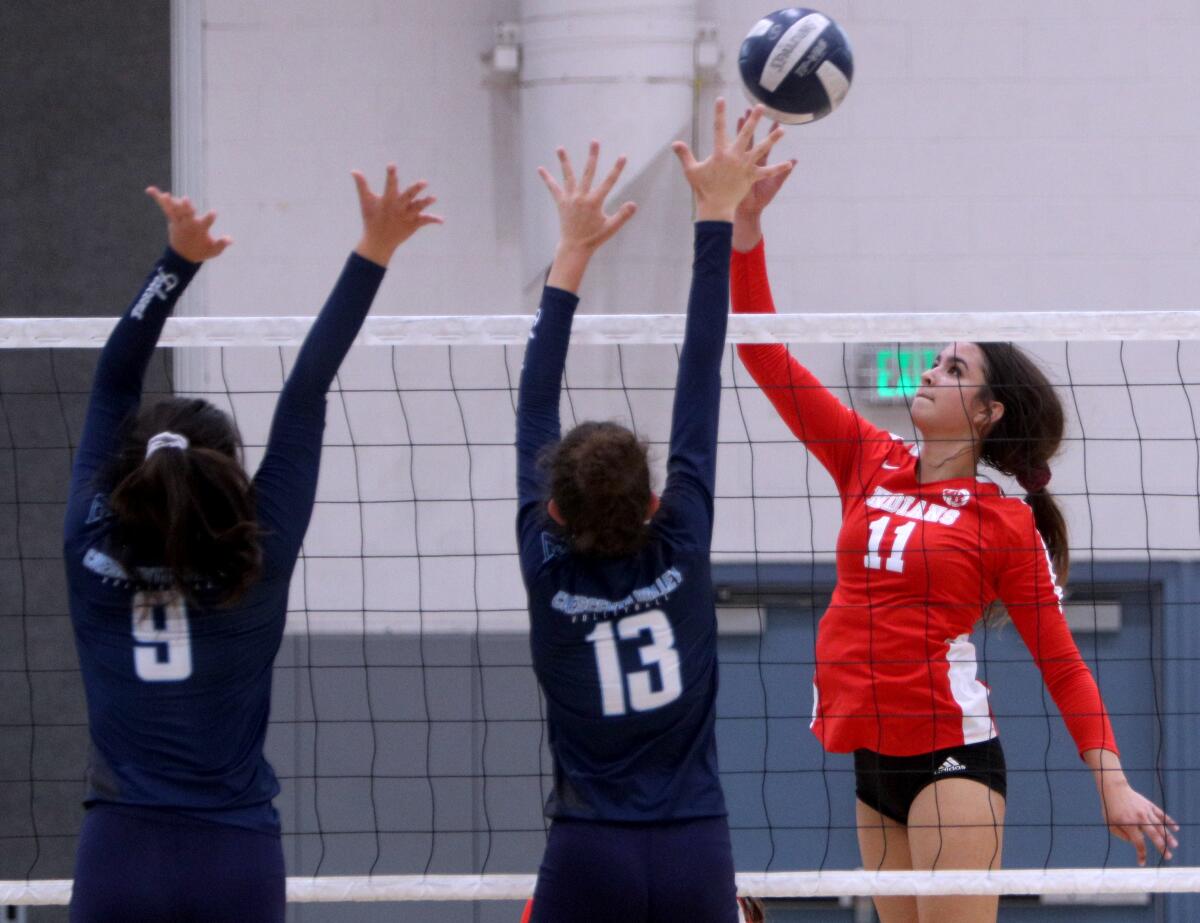 Burroughs High School volleyball player Catie Virtue drops one over the defense in away game vs. Crescenta Valley High School, in La Crescenta on Thursday, Sept. 12, 2019.