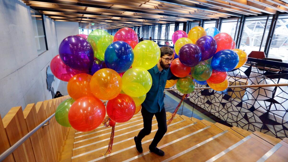 A delivery driver brings balloons into an Amazon building for a company event. Amazon's buildings are home to 34 restaurants.