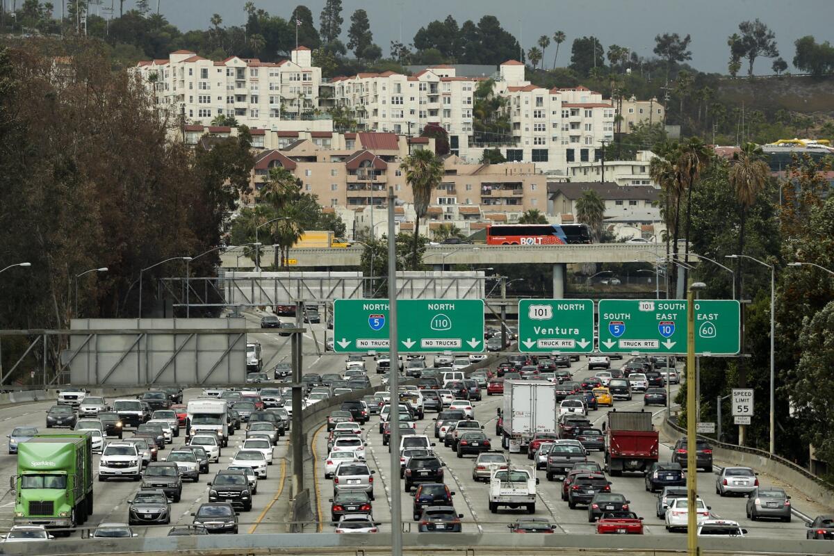 Traffic slowly moves along the 110 Freeway during afternoon rush hour in downtown Los Angeles.