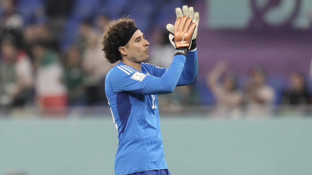 Mexico's goalkeeper Memo Ochoa claps to acknowledge supporters after a draw with Poland