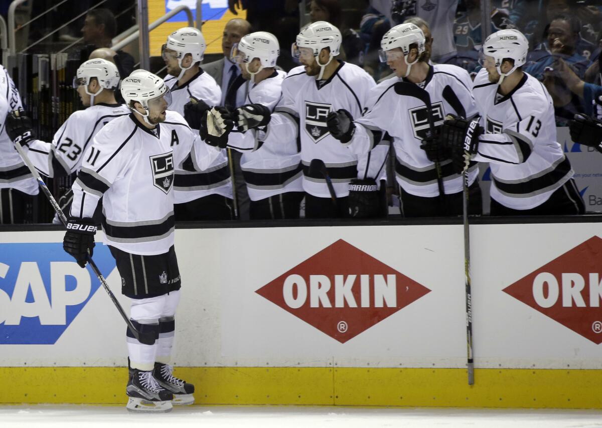 Kings forward Anze Kopitar (11) celebrates his goal with teammates on the bench during the first period of Game 3.